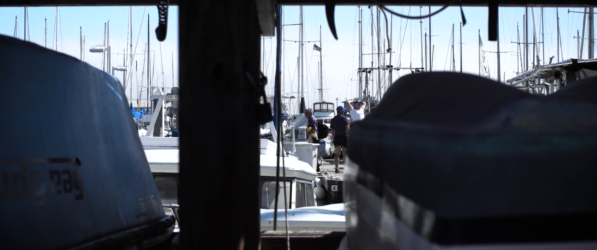 Marina view framed through a darker foreground interior with boats beyond